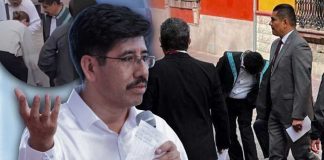 Captan a acompañantes limpiando los zapatos a Hugo Aguilar previo a acto por la Constitución en Querétaro